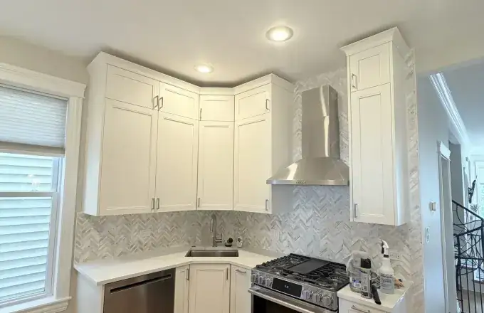 Logan Square kitchen remodel at 2966 N Wisner Ave with White Dove double-shaker cabinets, Calacatta quartz and gold chevron backsplash