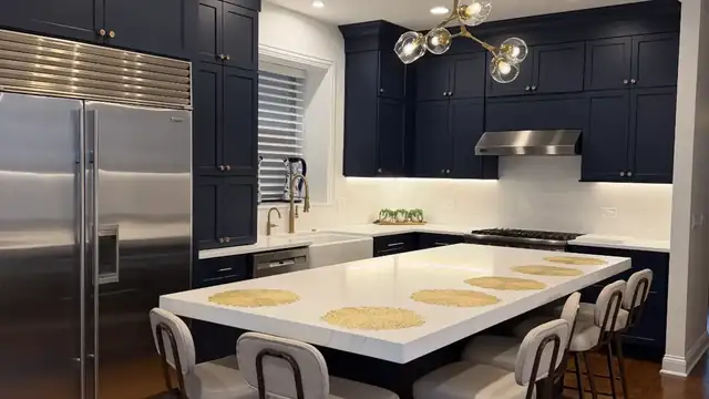Wicker Park whole-home remodel in Chicago, kitchen with navy island, stainless steel appliances and gold accents